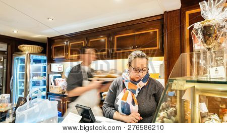 Strasbourg, France - Dec 29, 2018: Cashier Serving Clients In The Traditional French Pastry Store, R