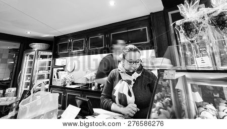 Strasbourg, France - Dec 29, 2018: Cashier Serving Clients In The Traditional French Pastry Store, R