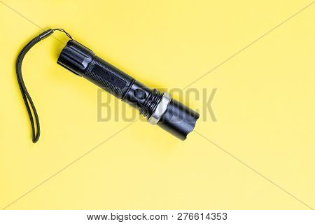 Blacc Metal Small Tactical Falshlight Isoltaed On Yellow Background