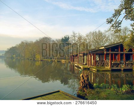 Boath House And Wooden Cabin On The Edge Of A Lake In Ireland.