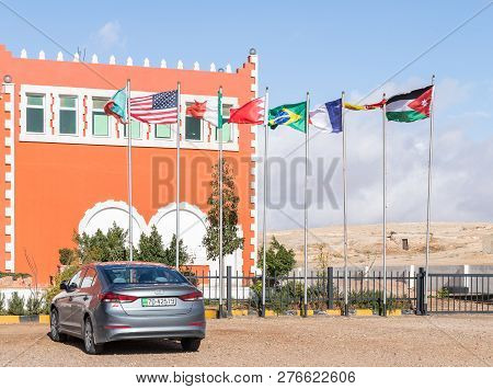 Maan, Jordan, December 07, 2018 : Several Flags Of Different Countries On Flagpoles Near The Roadsid