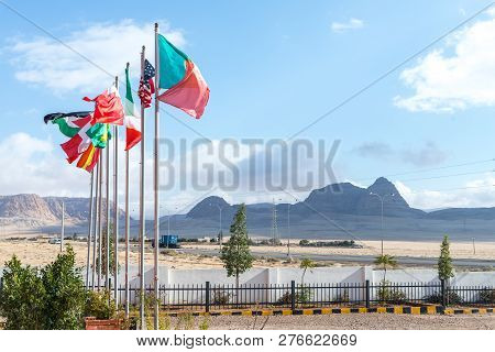 Maan, Jordan, December 07, 2018 : Several Flags Of Different Countries On Flagpoles Near The Roadsid