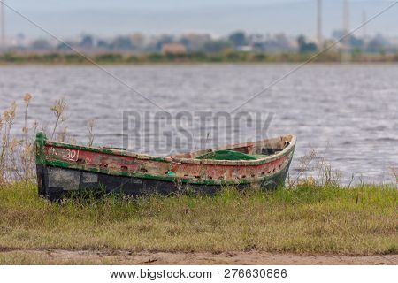 Boat Stranded On The Shore Of The Lagoon In The Natural Park Of Albufera, Valencia, Spain