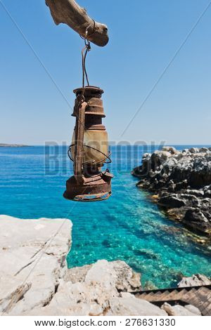 Old Dusty And Rusty Lantern Above Boat Dock Near Marmara Beach, Island Of Crete, Greece