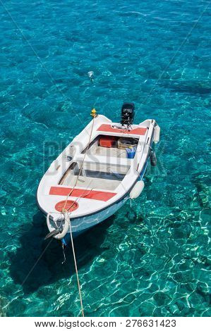White Boat At Crystal Clear Blue Water Of Marmara Beach, Near Aradena Gorge, Island Of Crete, Greece