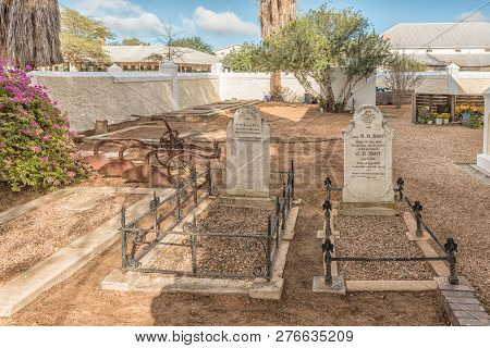 Clanwilliam, South Africa, August 28, 2018: An Historic Plow And Graves At The First Dutch Reformed 