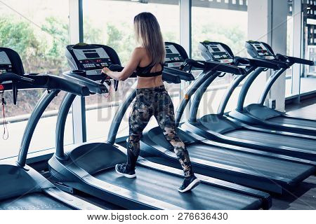 Young Fit Woman Doing Running Exercise In Gym