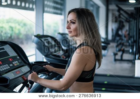 Young Fit Woman Doing Running Exercise In Gym