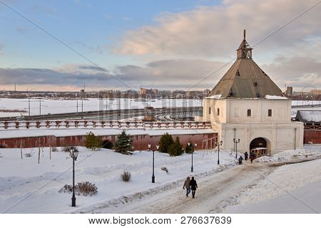 KAZAN, RUSSIA - JANUARY 4, 2015: Tourists near the Tainitskaya tower of Kazan Kremlin. Built in 1550s, the tower on the shot is under reconstruction