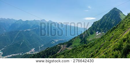 A Panoramic View Of The Valley With Apartment Buildings, Surrounded By Mountains With Cable Cars. Kr