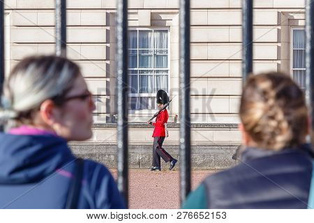 London, Uk - October 3, 2017 - Back View Of Two Tourists Watching A Sentry Of Grenadier Guards Patro