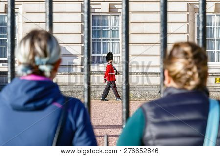 London, Uk - October 3, 2018 - Back View Of Two Tourists Watching A Sentry Of Grenadier Guards Patro