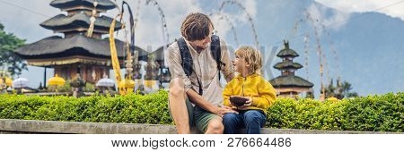 Dad And Son In The Background Of Pura Ulun Danu Bratan, Bali. Hindu Temple Surrounded By Flowers On 