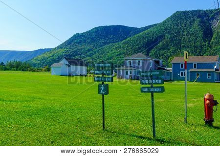 Mont-saint-pierre, Canada - September 13, 2018: Typical Wooden Houses And Trail Directional Signs In