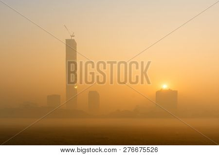 Beautiful Image Of Sunrise At Kolkata Maidan In A Foggy Winter Morning. Sunrises At The Horizon Abov