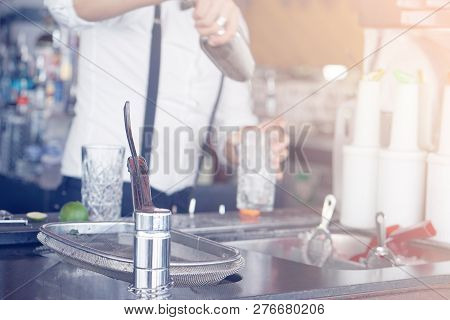 A Bartender Stirring Ingredients In A Mixing Glass In Order To Prepare And Serve A Chilled Cocktail 