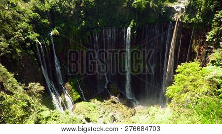 Waterfall Coban Sewu In Tropical Forest, Java Indonesia. Tumpak Sewu Waterfall In Rainforest Aerial 