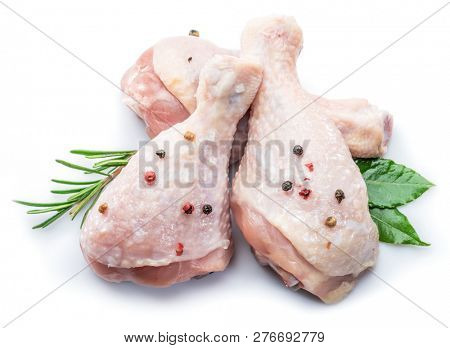 Chicken legs with spices isolated on white background.