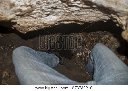 Shimmying Through A Tiny Crevasse In A Cave
