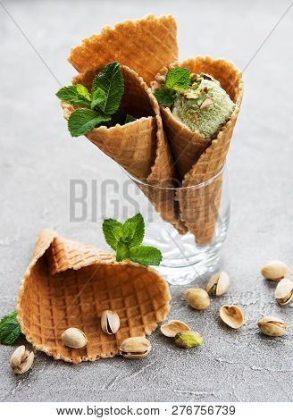 Pistachio Ice Cream And Mint With Pistachio Nuts On A Stonebackground