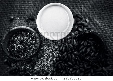 Close Up Of Paste Of Custard Apple Seeds In A Glass Bowl With Some Powdered Seeds And Raw Dried Seed