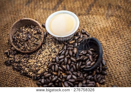 Close Up Of Paste Of Custard Apple Seeds In A Glass Bowl With Some Powdered Seeds And Raw Dried Seed