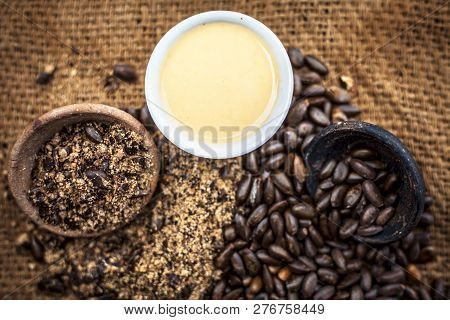 Close Up Of Paste Of Custard Apple Seeds In A Glass Bowl With Some Powdered Seeds And Raw Dried Seed