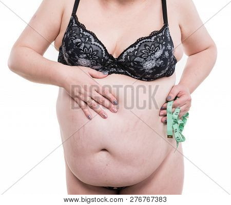 Overweight Woman Posing With Measure Tape On A White Background
