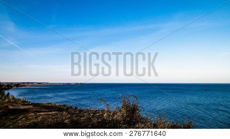Baltic Sea From Cliff In Mechelinki, Poland. Nature And Travel Concept. Copy Space On Blue Sky.