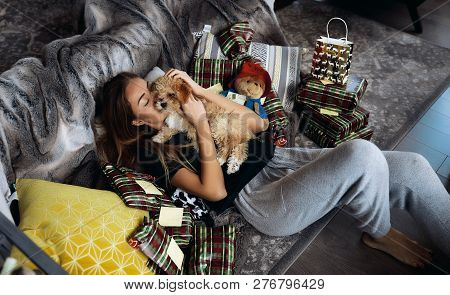 Careful Pretty Girl Kissing Her Sweet Fluffy Friend With Red Curlies. Lying On Sofa They Having Fun,
