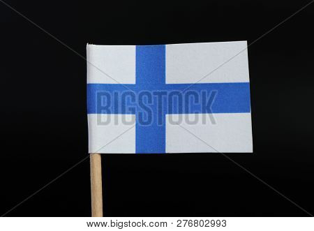 A Official Flag Of Finland On Toothpick On Black Background. Consists Of Sea-blue Nordic Cross On Wh