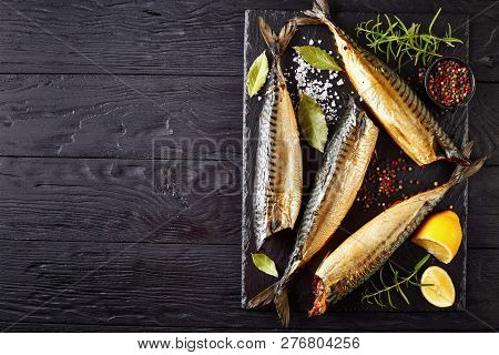 Hot Smoked Mackerel On A Black Slate Tray With Salt, Peppercorn, Rosemary And Lemon, View From Above