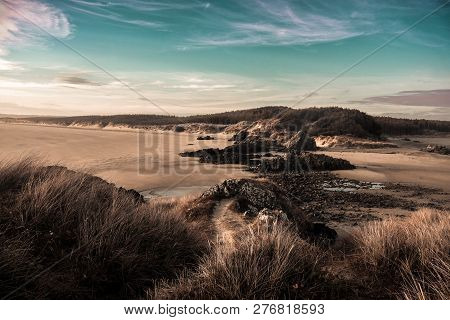 A Walk Along The Path To Ynys Llanddwyn Wales, One Of Anglesey`s Dramatic Coastlines. Overlooking Ne