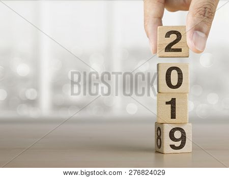Hand Arranging Wooden Blocks With The Word 2018 Change To 2019. Happy New Year, Start Up, Refresh, M