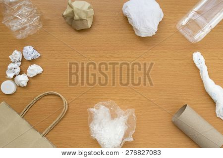 Top View Of Recycling Garbage Waste On Wooden Background With Center Copy Space , Eco And Save World