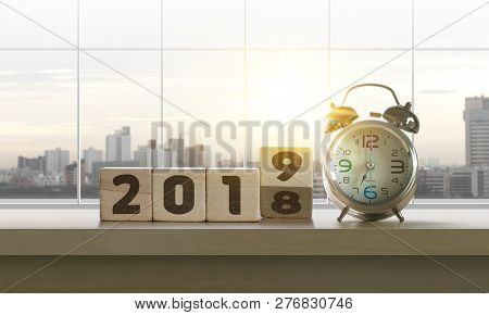 Wooden Blocks With The Word 2019 And Clock On Table With Panoramic City Skyline Background In The Mo