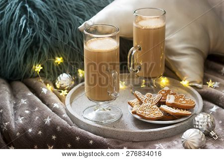 Homemade Latte In Glass Cups, Served With Gingerbread On The Background Of Plaid, Pillows And Garlan