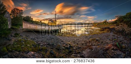 Old Boat In Old Harbour With Kyleakin Castle In Background, Isle Of Skye, Scotland