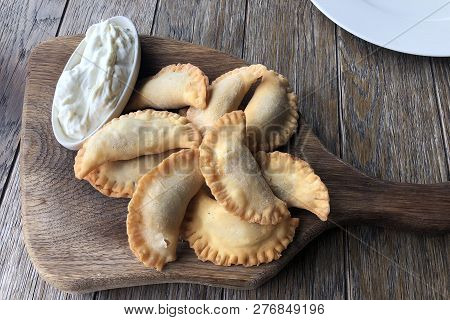 Big Fried Dumplings (manti, Ravioli, Gyoza) With Meat - Traditional Cuisine, With Cream Sause On The
