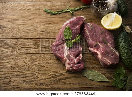 Seasoning Meat With Garlic Lemon Rosmary Cucamber Wooden Background