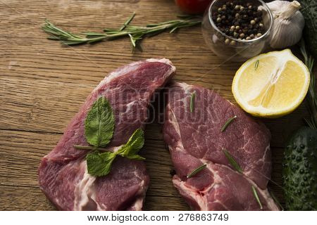 Seasoning Meat With Garlic Lemon Rosmary Cucamber Wooden Background