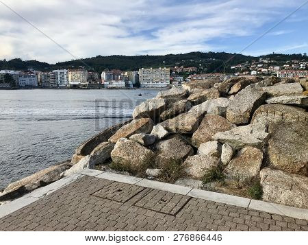 View Of The Harbour From Over Some Rocks On Galicia Spain