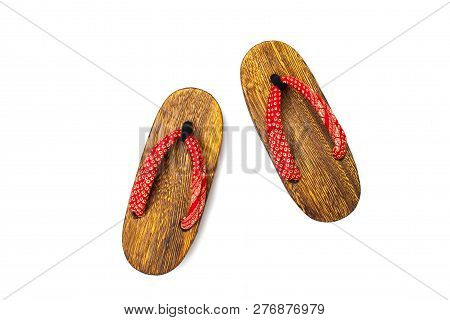 Close Up Old Used Wooden Japanese Sandal Isolated On White Background. It Is A Form Of Traditional J