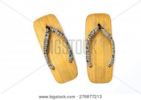 Close Up Old Used Wooden Japanese Sandal Isolated On White Background. It Is A Form Of Traditional J