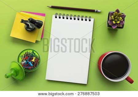 Notebook On Office Table With A Cup Of Coffee, Plant, Stationery And Office Supplies. Blank Notepad 