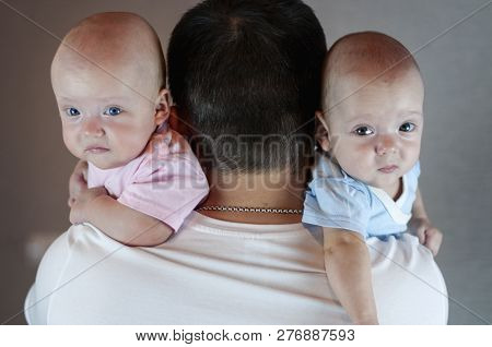 Young Dad Changes The Diaper And Clothes To His Newborn Small Child. Selective Focus