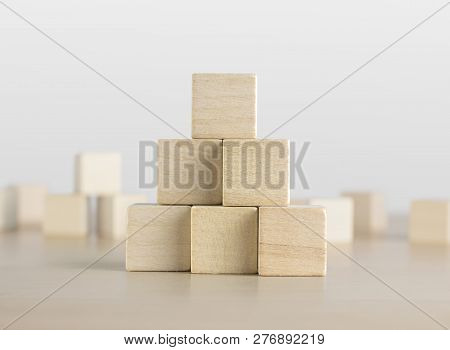 Wooden Blocks Stacking As A Pyramid Staircase On White Background. Success, Growth, Win, Victory, De