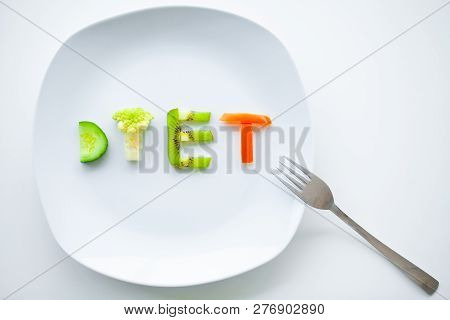 Diet Or Weight Control Concept. Centimeter Tape And Fork On A White Background With A Place For Inse