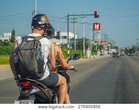 Chiang Rai, Thailand: November 23, 2018 - Couple Foreign Backpack Traveler Wearing Helmet Parking Mo