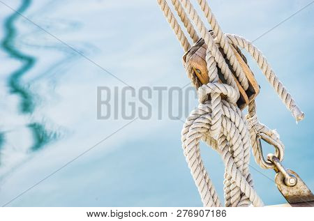 Detail Image Of Wooden Pulley With Ropes Of An Classical Sailing Yacht